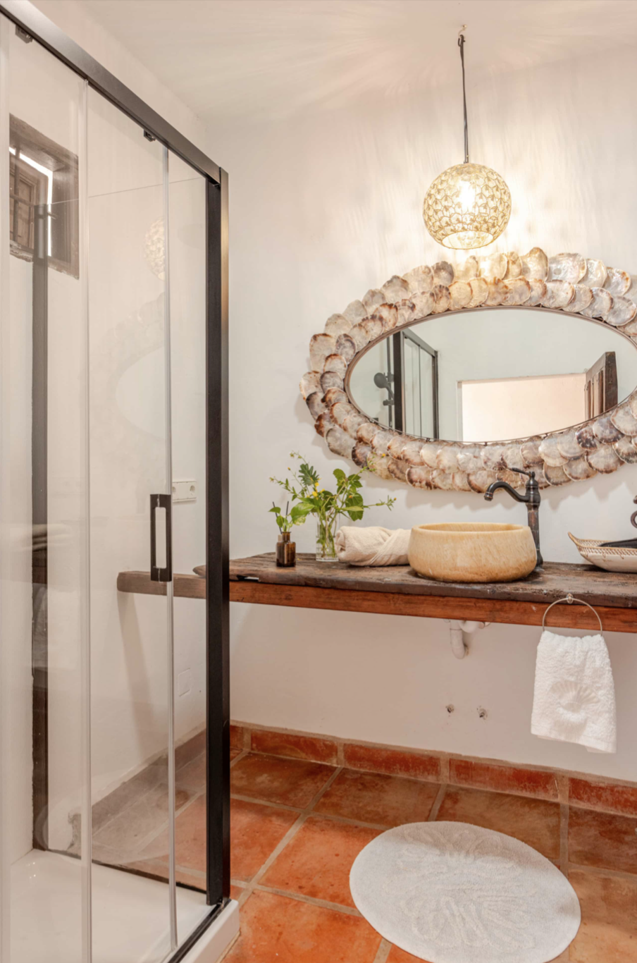 Bathroom with stone basin and shell mirror