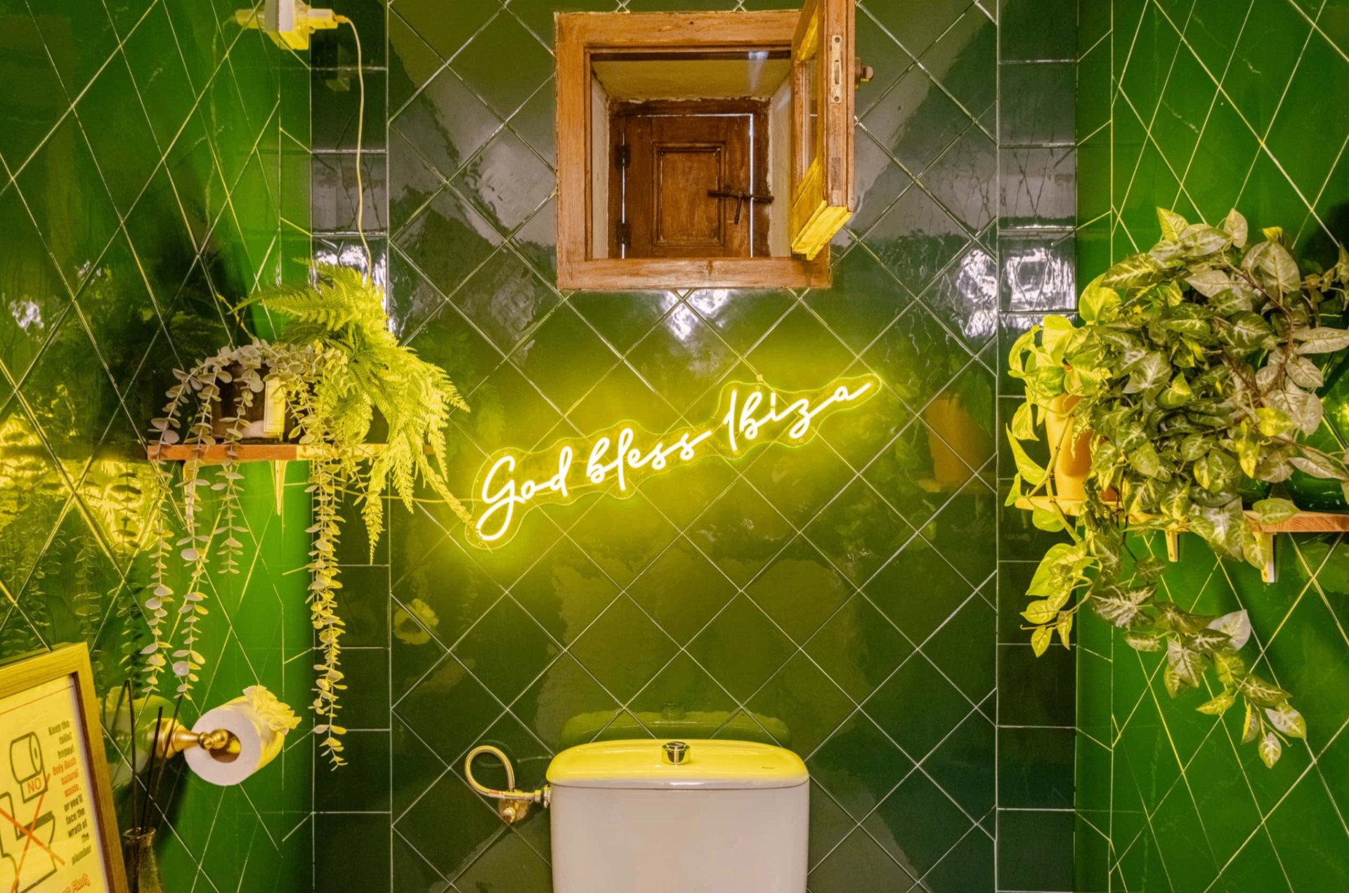 Green-tiled guest toilet with Ibiza neon sign