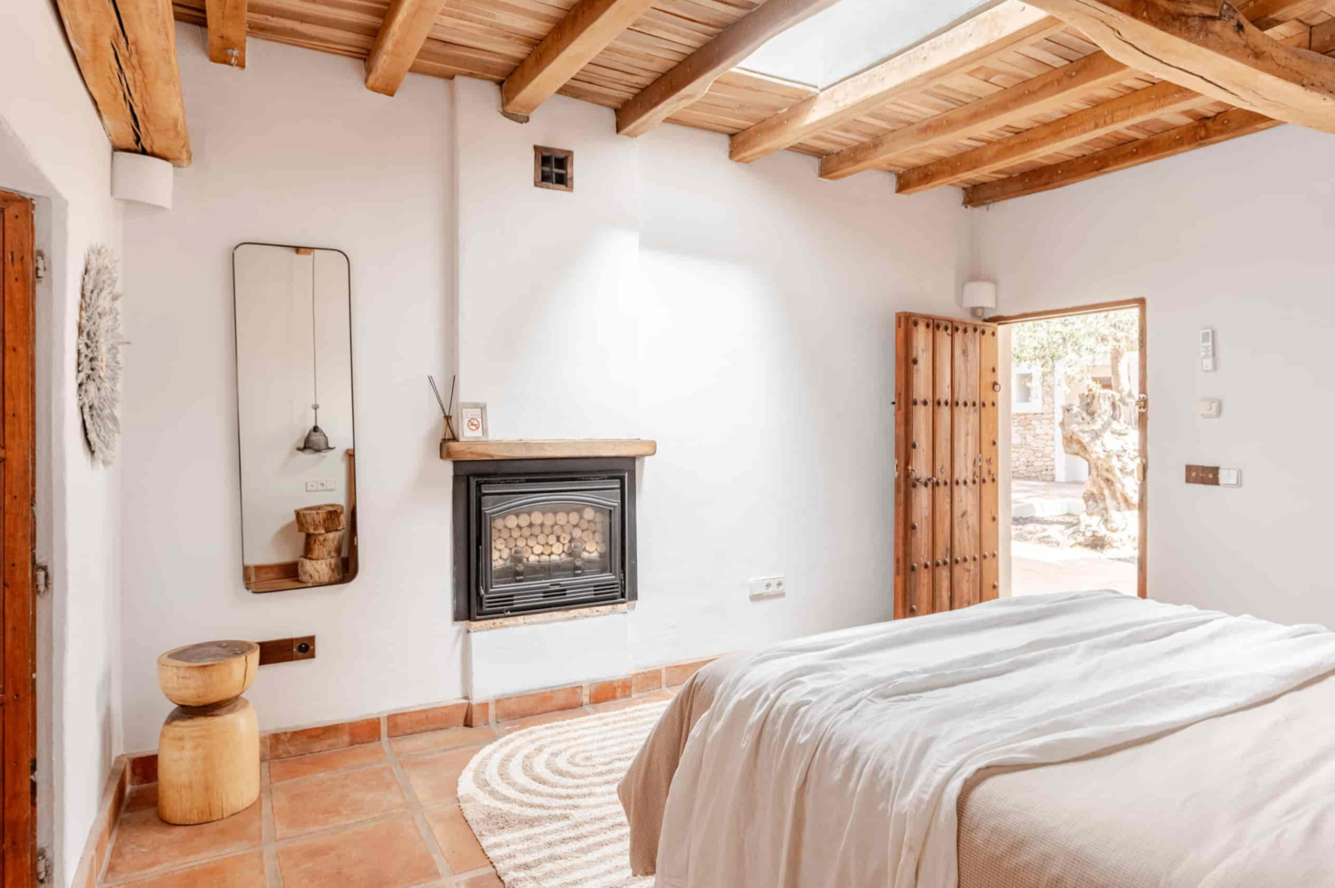 Bedroom with fireplace and skylight