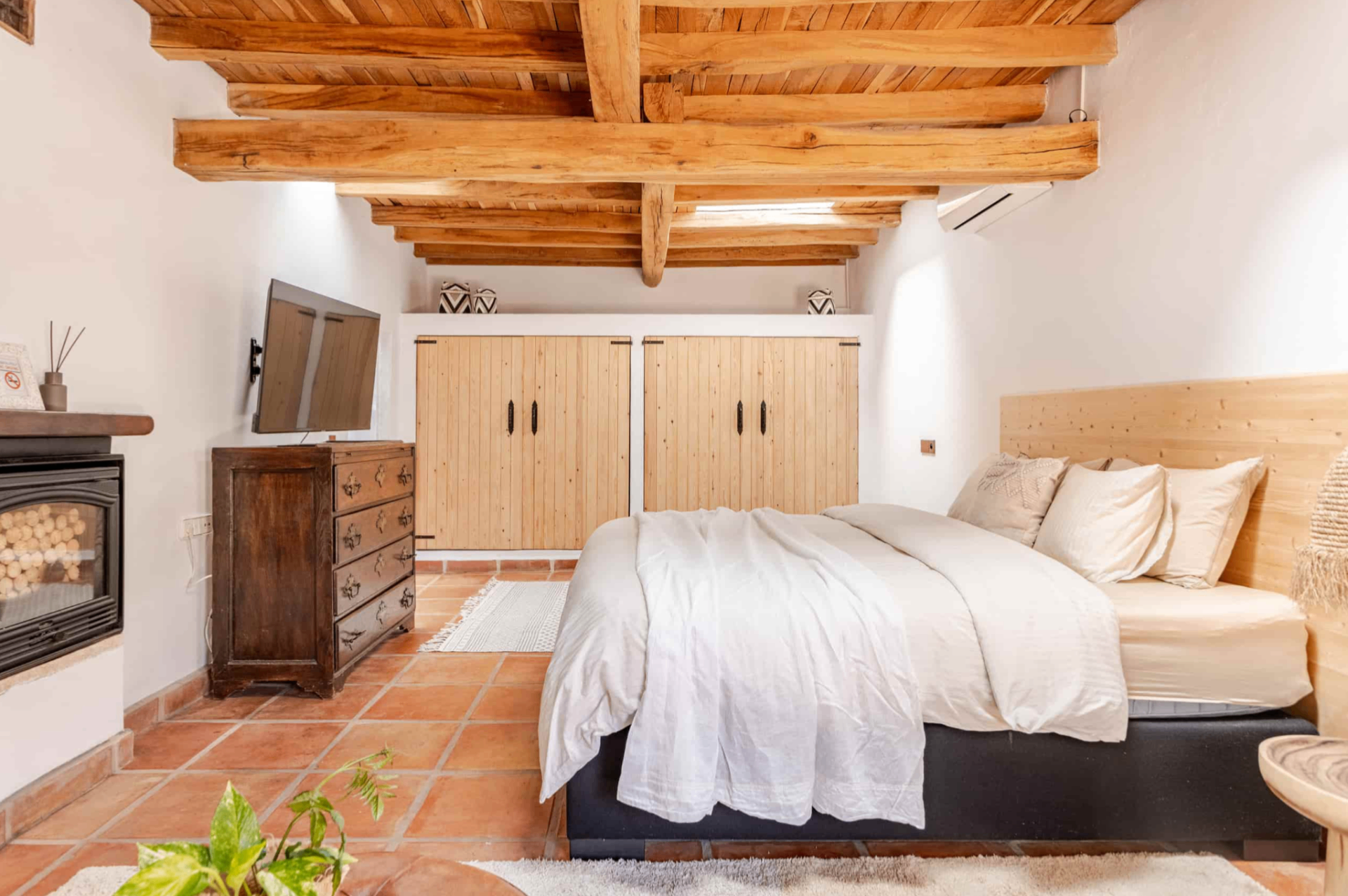 Bedroom with TV and fireplace