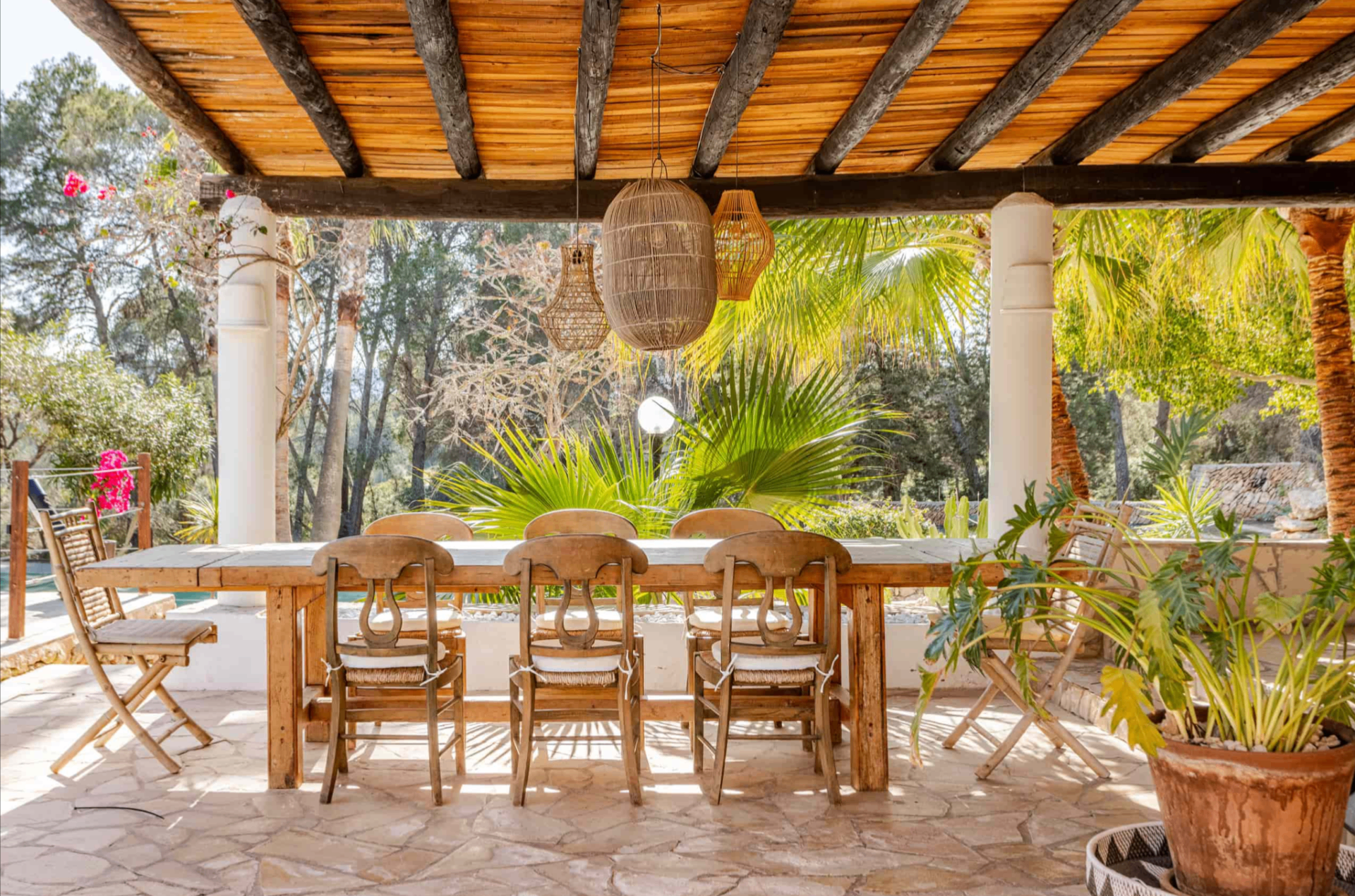 Garden dining table beneath timber beams